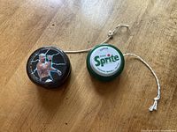 Top view showing Stone Cold Steve Austin image on WWF black yo-yo and Sprite logo on green yo-yo