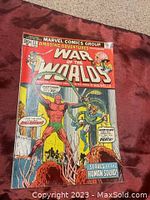 Front cover of Amazing Adventures #22 featuring Killraven in War of the Worlds storyline with vibrant red background and detailed character illustrations.