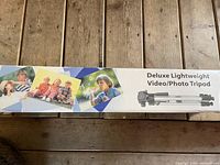 Tripod box top with text and images describing the product as Deluxe Lightweight Video/Photo Tripod