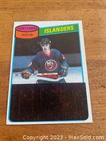 Front of hockey card showing Mike Bossy in Islanders uniform with unscratched black box on bottom half and team leaders label.