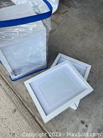 Eight white picture frames laid out, showing front side with clean white finish and size proportions