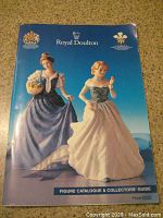 Front cover of the Royal Doulton Figure Catalogue & Collectors Guide showing two figurines in blue and cream dresses, blue background, price marked £2.50.
