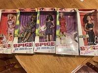 Full set of 5 boxed Spice Girls dolls shown side by side revealing all boxes and doll outfits.