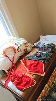 Photo of blouse, vests, skirt, apron, and phrase book on wooden surface