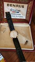 Vintage Benrus Citation watch with black leather strap inside original red presentation box lined with satin and velvet, showing missing crystal and condition.