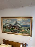 Wide shot of the wall art showing the full framed painting depicting horse and barn in country scene.