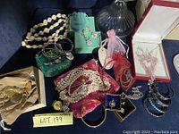 Assortment of jewelry pieces including necklaces, bracelets, earrings, rings, watch and gift boxes