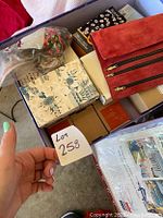 Photo showing the lot with multiple boxed items and plastic wrapped holiday ornaments.