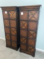 Two tall dark brown accent cabinets side by side showing front view