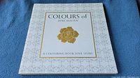 Front cover of 'Colours of Jane Austen' adult colouring book showing title and floral design
