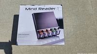 Photo shows the Mind Reader coffee pod dispenser in its original box with a picture of the product and some coffee pods displayed.