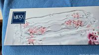 Photo of Mikasa branded box showing the floral pink frost glass tray with clear, decorative wavy edges and pink floral details on top.