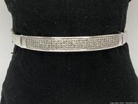 Frontal view of bracelet on black stand showing pave diamond panel