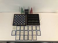 Overview of folding board, tray of pieces, informational cards, and box