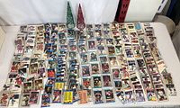 Wide view of the hockey card lot spread out on a white surface showing hundreds of assorted cards.