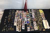 Wide shot showing numerous hockey cards spread across a table including black bordered and colorful player card designs.