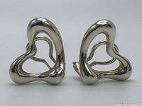 Front view of polished open-heart clip-on earrings side by side