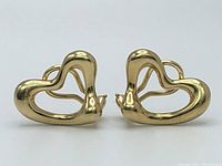 Front view of both open heart earrings on white background