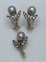 Front view of pair of earrings and pendant