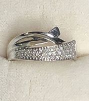 Front view of ring showing pavé diamond panel and crossover band