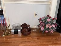 Full lot with three pairs of brass candleholders, wooden salad serving set, two glass bowls, silver plate utensils, and silk bouquet.