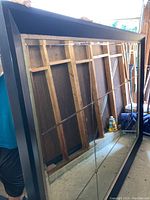 Back side of the mirror showing wooden support frame and structure.