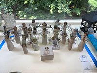 Overview of all 19 Willow Tree angel figurines and square trinket box with angel detail on lid.