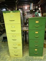 Front view of two vintage metal filing cabinets, one yellow with five drawers on the left and one green with four drawers on the right, located in a basement with various surroundings.