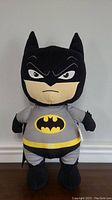Front view of plush Batman doll showing full body, costume details, and facial expression.