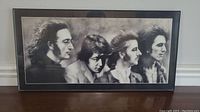 Framed black and white picture of The Beatles members in profile view, showing John Lennon, Paul McCartney, George Harrison, and Ringo Starr in a horizontal format.