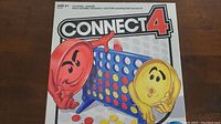 Connect 4 game box front with artwork showing red and yellow discs and blue grid.