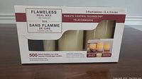 Box packaging of the flameless LED candle set listing the features: real wax, remote control technology, and 500 hours battery run time