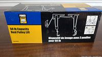 Box of Power Fist 50 lb Capacity Dual Pulley Lift showing brand and product info.