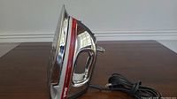 Front side view of a Shark steam iron showing the soleplate and handle.