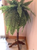Full view of solid oak fern stand with faux green fern foliage, showing the overall size and appearance.
