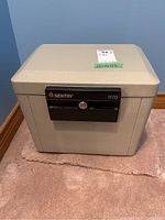 Image showing the full security lock box in light gray with lock area on the front.