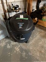 Full view of Shop-Vac showing body, hose, wheels, and power switch.