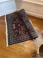 Runner rug partially rolled showing pile and fringe