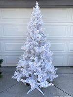 Front view showing the full 6-foot white Christmas tree with multicolored lights illuminated.