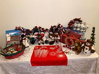 Wide shot of the entire set including snowmen dolls, cards, small tree, garlands, and ornaments.