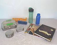 Photo showing all containers, water bottles, extra sleeves, and cookbooks grouped together