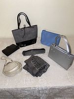 Overview of six items: five small bags/pouches and one scarf, displayed on a table