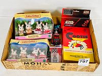 Lot box showing Calico Critters playsets, Star Wars card box, WWF figure, and Cootie game box