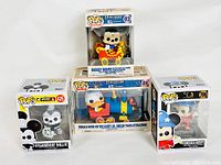 Set of four Funko Pop Disney vinyl figures in original boxes shown together. Figures include Steamboat Willie Mickey Mouse, Donald Duck on a circus train, Mickey Mouse on the circus train, and Sorcerer Mickey.