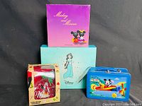 Photo showing four Disney items: Mickey and Minnie ornament box, Princess Jasmine beauty products box, Mickey Mouse lunch box, and Christmas shoe ornament box.