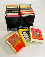 Photo of 8 black cassette cases with labels, three loose tapes with visible front covers of Frank Sinatra and Cadillac compilation.