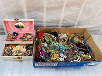 Overall collection of vintage estate jewellery in a pink-lined jewellery box and cardboard tray