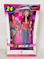 Front view of the sealed Barbie doll in original pink and white NASCAR themed box showing the doll fully dressed and Jeff Gordon image on the side panel.