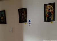 Photo of three Asian-themed oil paintings framed and hung on a wall showing overall lot.