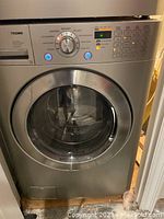 Front view of LG Tromm washer showing control panel, drum and exterior finish
